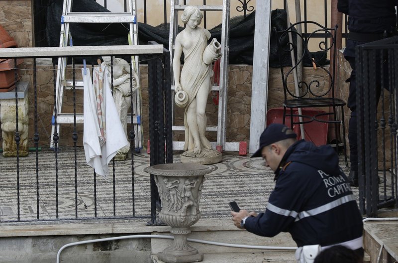 Αστυνομικός φωτογραφίζει αντικείμενα που βρέθηκαν στις βίλες (Φωτογραφία: ΑΡ)