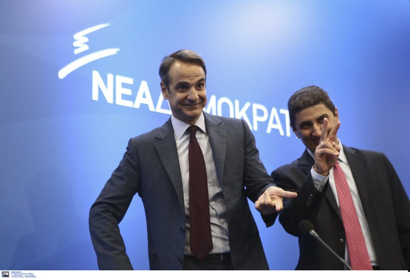 Το σήμα της νίκης κάνει ο γραμματέας της ΠΕ Λευτέρης Αυγενάκης, δίπλα στον πρόεδρο της ΝΔ