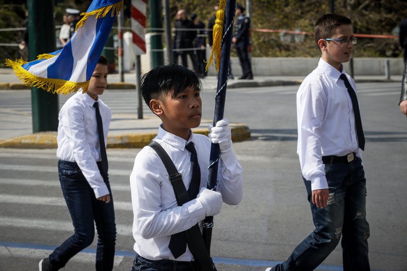 Τα φλας άστραψαν στον νεαρό που σηκώνει την ελληνική σημαία