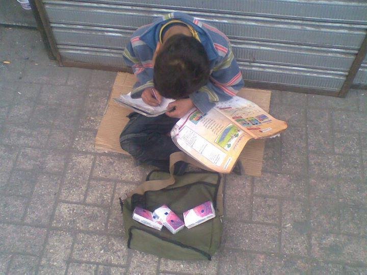 Μια εικόνα που σοκάρει -Παιδάκι πουλάει χαρτομάντιλα και διαβάζει τα μαθήματά του [εικόνα] | iefimerida.gr 0