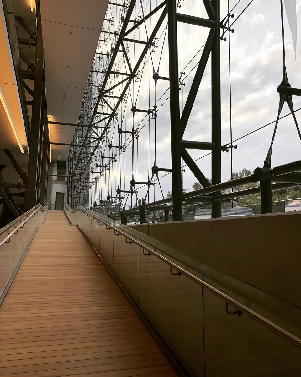 Οι ράμπες που διατρέχουν το κτίριο από τον δεύτερο υπόγειο ως τον τρίτο όροφο έγιναν το σήμα κατατεθένα της Εθνικής Πινακοθήκης στο νέο της σήμα.