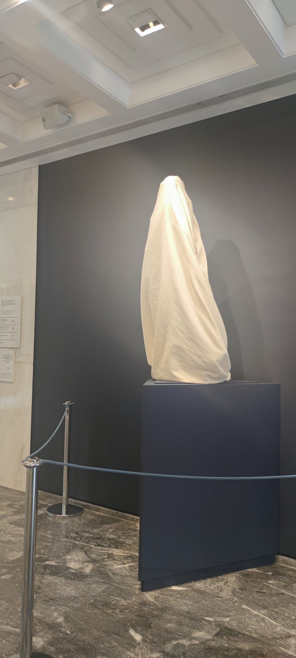 Τυλιγμένο με ένα πανί, το άγαλμα περιμένει να αποκαλυφθεί στα εγκαίνια της έκθεσης Κάλλος.