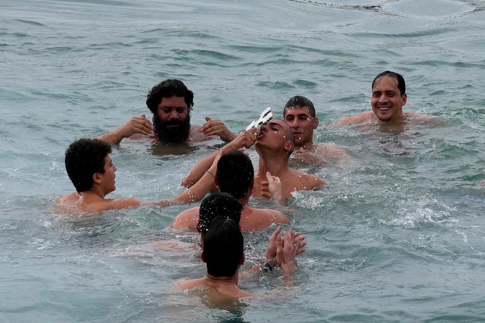 Φιλά τον Σταυρό που έπιασε κατά τον εορτασμό των Θεοφανίων στην Κύπρο, στο νοτιοανατολικό θέρετρο της Αγίας Νάπας/ AP Photo/Petros Karadjias