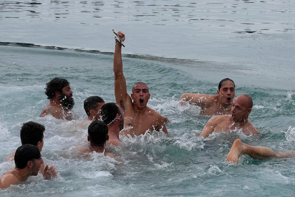 Κρατά τον Σταυρό αφού τον πέταξε ο ιερέας στο νερό, κατά τη διάρκεια μιας τελετής των Θεοφανίων για την ευλογία της θάλασσας, στο νοτιοανατολικό θέρετρο της Αγίας Νάπας στην Κύπρο/ AP Photo/Petros Karadjias