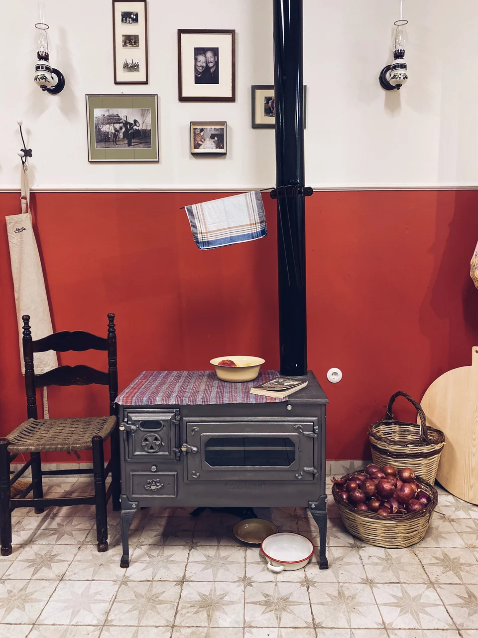 Μια ξυλόσομπα, καλάθια με κρεμμύδια, παλιές φωτογραφίες σε κάδρα, λάμπες πετρελαίου, συνθέτουν το σκηνικό μιας αυθεντικής παλιάς κουζίνας του χωριού / Φωτογραφία: Μάνος Λειβαδάρος/iefimerida