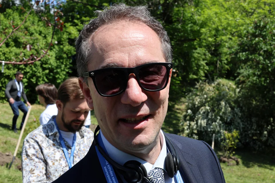 a man wearing sunglasses and a suit