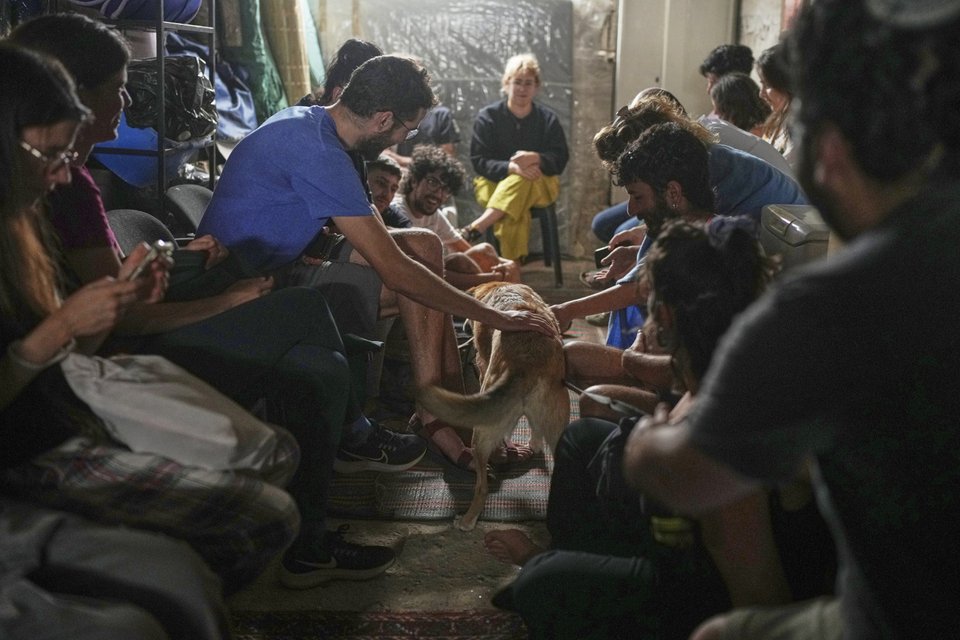 Ισραηλινοί βρίσκουν καταφύγιο σε ένα υπόγειο καθώς μια σειρήνα ηχεί ως προειδοποίηση μετά από εκτοξεύσεις πυραύλων από το Ιράν, στην Ιερουσαλήμ, την Κυριακή 15 Ιουνίου 2025 / Φωτογραφία AP