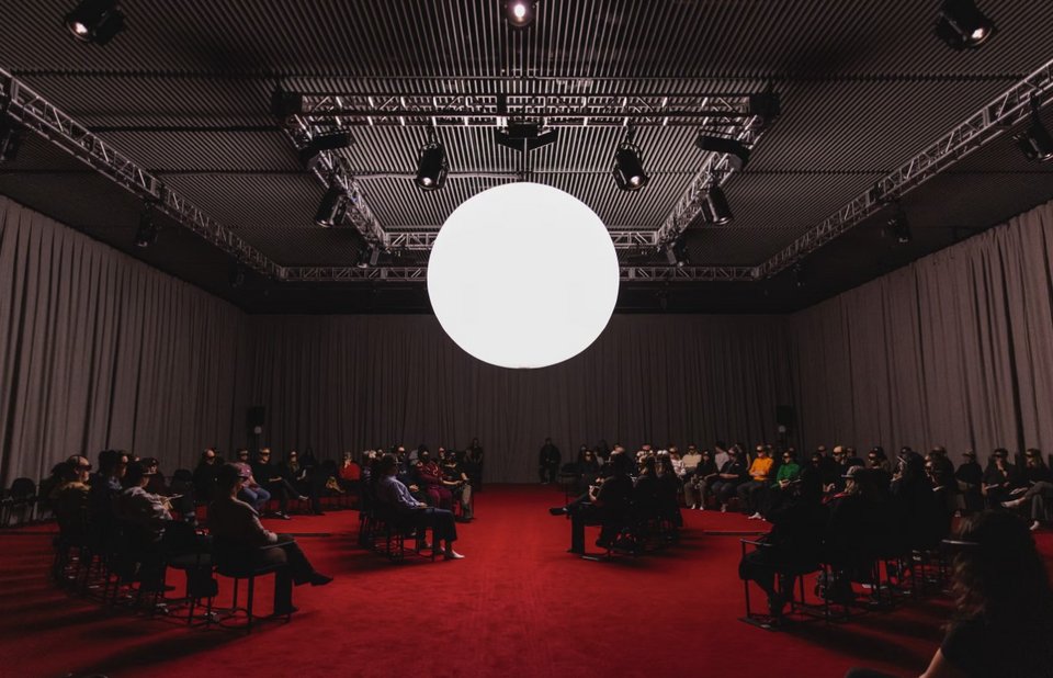 Σε μια διάρκεια 47 λεπτών, οι τέσσερις χαρακτήρες απευθύνονται απευθείας στον θεατή, ακολουθώντας τις ζωές τους από τη γέννηση έως τον θάνατο, με σταθερή οπτική επαφή που δημιουργεί μια έντονα προσωπική εμπειρία / THE SHED 