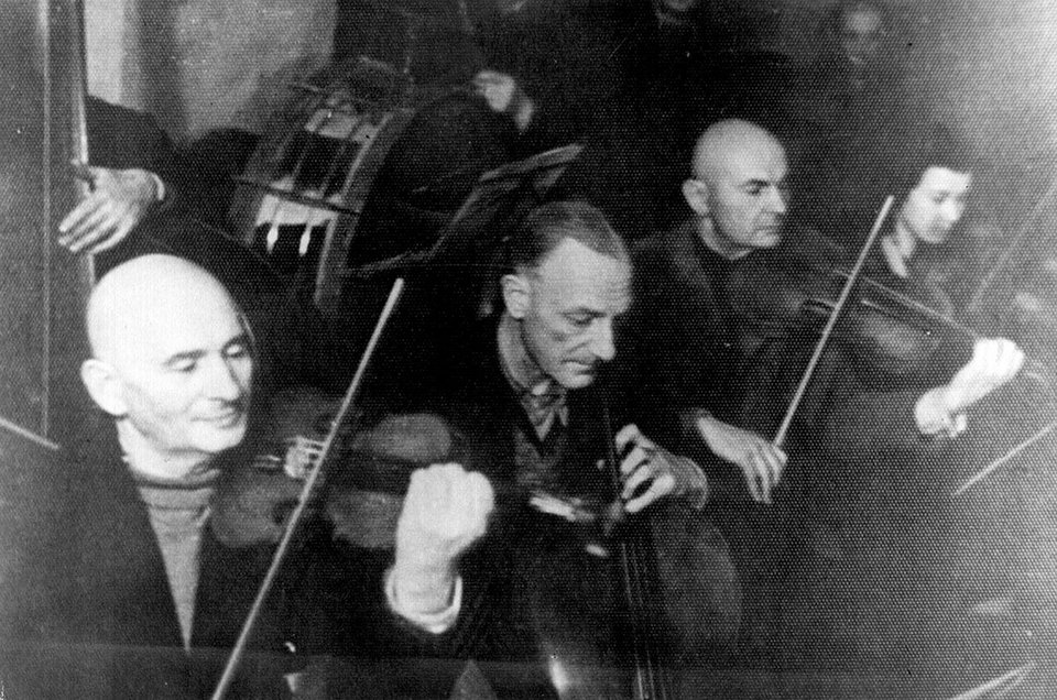 Οι Γερμανοί είχαν δημιουργήσει μουσικά σύνολα μέσα στα στρατόπεδα. Αναζητούσαν επαγγελματίες μουσικούς που θα μπορούσαν να στελεχώσουν τις ορχήστρες των κρατουμένων. Ο Στρούμσα επιλέχθηκε ως βιολιστής / WIKIPEDIA