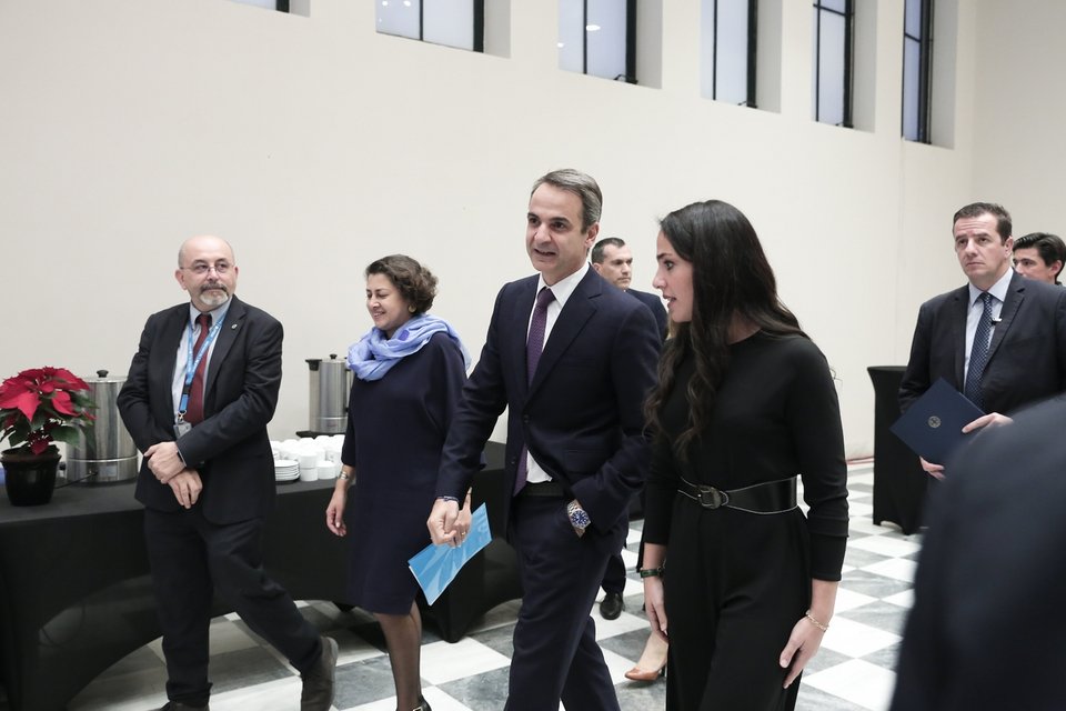 Η Δόμνα Μιχαηλίδου συνοδεύει τον πρωθυπουργό στην αίθουσα της εκδήλωσης