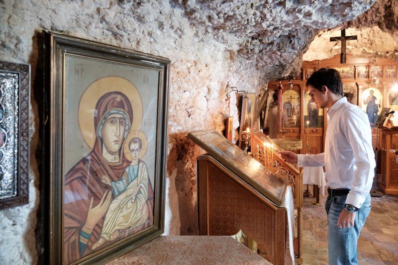 Ο Ο γιος του Κυριάκου Μητσοτάκη, Κωνσταντίνος ανάβει κερί