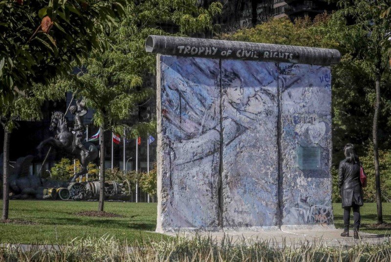 Τμήμα του Τείχους του Βερολίνου με ζωγραφιά δύο ανθρώπων που αγκαλιάζονται