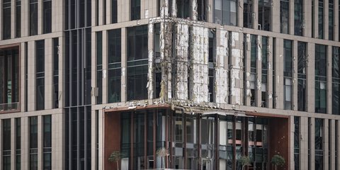 Η μερικώς κατεστραμμένη πρόσοψη ενός κτιρίου στην οικονομική περιοχή του Ντουμπάι, από πτώση συντριμμιών drone - 13 Μαρτίου 2026. (AP Photo/Altaf Qadri)