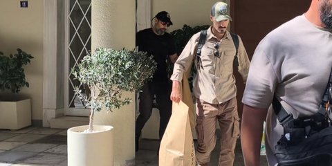 Αστυνομικοί βγάζουν σακούλες με στοιχεία από το ιδιωτικό ιατρείο στο Κολωνάκι όπου έχασε τη ζωή του ο Γιώργος Μαζωνάκης