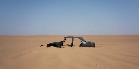 Ενα εγκαταλελειμμένο αυτοκίνητο στην έρημο Σαχάρα -Στο δρόμο που πια χρησιμοποιούν πρόσφυγες -Φωτογραφία: AP Photo/Jerome Delay