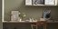 Γραφείο στο σπίτι, με τραπέζι, καρέκλα, ράφι και πίνακες με έργα τέχνης