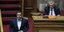Ο Αλέξης Τσίπρας κατεβαίνει από το βήμα της Βουλής υπό το βλέμμα Παπαγγελόπουλουκατά Παπαγγελόπουλου