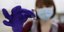 Νοσηλεύτρια κρατά ένα φιαλίδιο με το εμβόλιο κατά του κορωνοϊού
