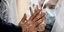 Συγγενής ασθενούς με κορωνοϊό στη Ρώμη, ακουμπά το χέρι του πίσω από πλαστικό παραπέτασμα