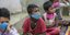 Παιδιά καθιστά με μάσκες στην Ινδία 