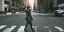 Γυναίκα με μάσκα περνάει από διάβαση πεζών στη Νέα Υόρκη