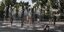 Children play with the water on a fountain