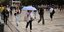 People with umbrellas in Athens