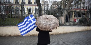 Γυναίκα με ελληνική σημαία και ομπρέλα