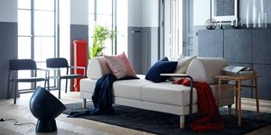 Σαλόνι διαμερίσματος με λευκό καναπέ, μαξιλάρια, συρταριέρα, κάδρο στον τοίχο