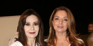 Η Κάτια Δανδουλάκη με λευκό πουκάμισο και παντελόνι με λουλούδια και η Αντζελα Γκερέκου με μαύρο φόρεμα