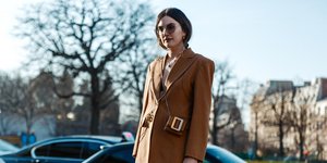 Γυναίκα φορά καφέ κοστούμι