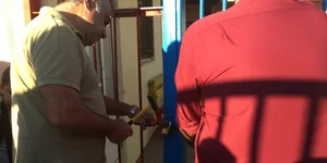 Ανδρας ανοίγει κλειδαριά σχολείου