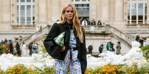 Γυναίκα με τζιν και τσάντα ποζάρει