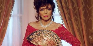 η Τζόαν Κόλινς με φόρεμα και βεντάλια σε καμπάνια του Valentino