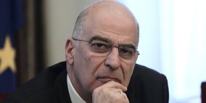 Ο υπουργός Εξωτερικών Νίκος Δένδιας σκεπτικός με το χέρι στο πρόσωπο