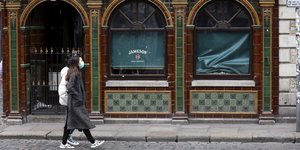 Γυναίκα με μάσκα σε δρόμο της Ιρλανδίας