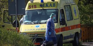 Γιατρός με στολή δίπλα σε ασθενοφόρο