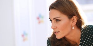 Η Κέιτ Μίντλετον με πουκάμισο και σκουλαρίκια κοιτά