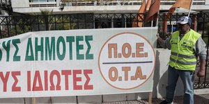 Απεργός δίπλα σε πανό της ΠΟΕ-ΟΤΑ