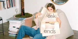 Γυναίκα κρατάει εφημερίδα και κρύβει το πρόσωπό της