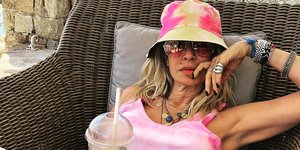 Η Αννα Βίσση με καπέλο και καφέ στο χέρι 