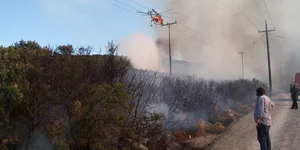 Ελικόπτερο πάνω από καπνούς σε φωτιά σε δάσος