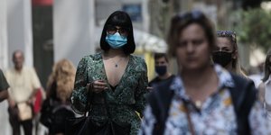 Γυναίκα με μάσκα και γυαλιά ηλίου στο κέντρο της Αθήνας