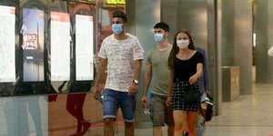 Νεαροί περπατούν σε υπόγειο σταθμό της Αυστρίας φορώντας μάσκες