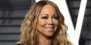 Η Μαράια Κάρεϊ με πράσινο σκούρο φόρεμα