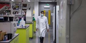 Άνδρας με στολή γιατρού και μάσκα σε κλινική στη Βρετανία