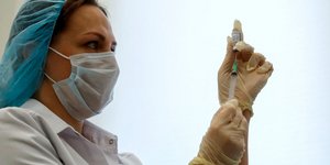 Νοσοκόμα κρατά σύριγγα με το εμβόλιο Sputnik-V