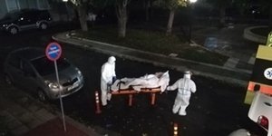 Τραυματιοφορείς μεταφέρουν ασθενή σε φορείο