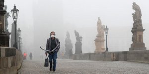 Άνδρας με μάσκα στην ομιχλώδη πρωτεύουσα της Τσεχίας, την Πράγα