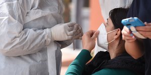γυναίκα με μάσκα κάνει rapid test